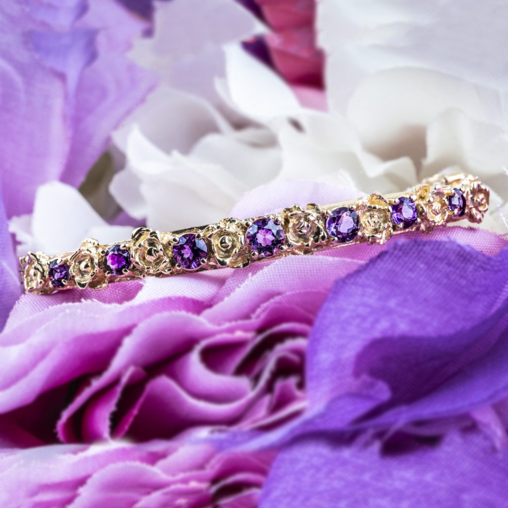 Yellow gold floral tennis bracelet set with amethyst.