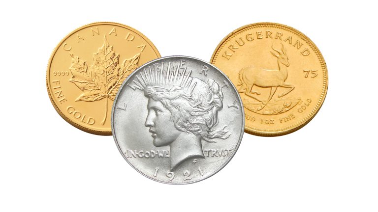 Three historic American silver and gold dollar coins.