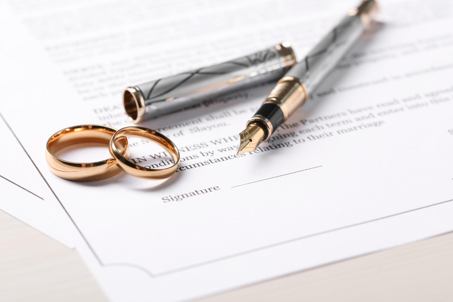 2 Rings and a pen on top of a document