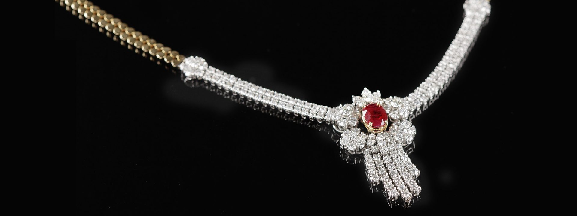 Diamond pendant with ruby in the center.